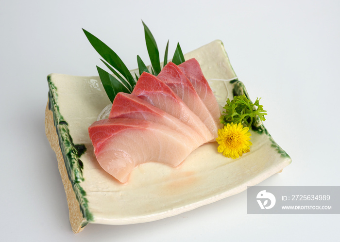 Sliced raw Hamachi sashimi on plate