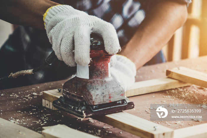 Carpenter working on wood craft at workshop to produce construction material or wooden furniture. Th