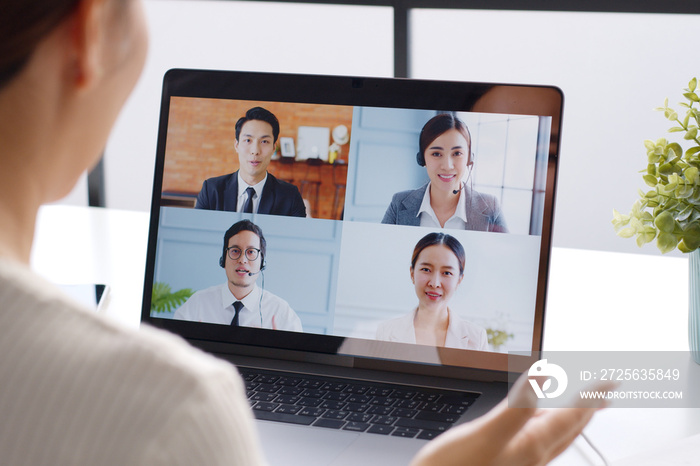 Young Asian businesswoman work at home and virtual video conference meeting with colleagues business