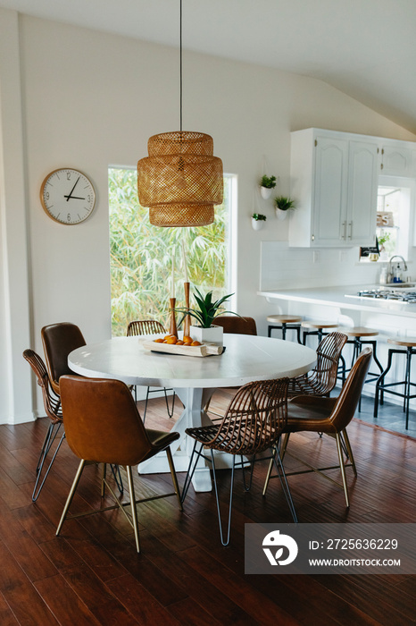 Brown chairs arranged by dining table at home