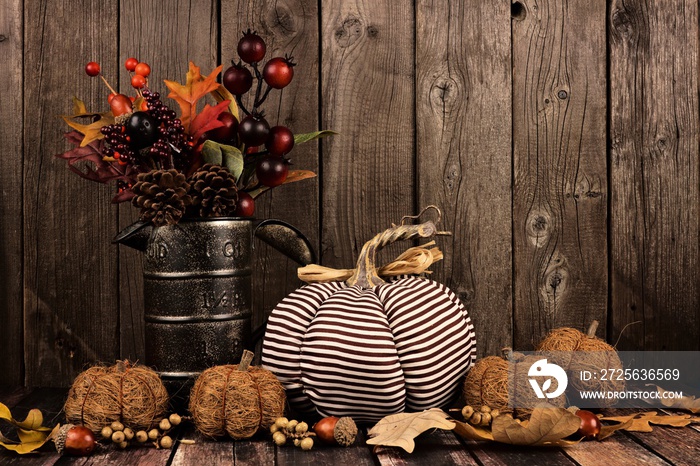 Shabby chic pumpkins and autumn home decor with rustic wood background