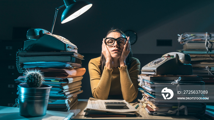 Exhausted businesswoman working late at night