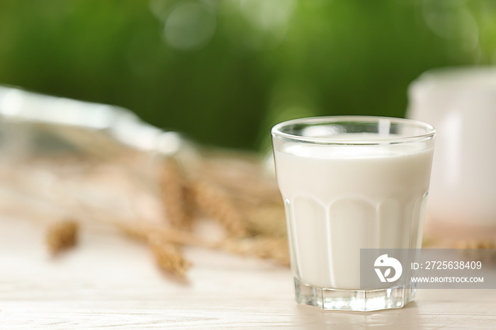 Glass of fresh milk on light table