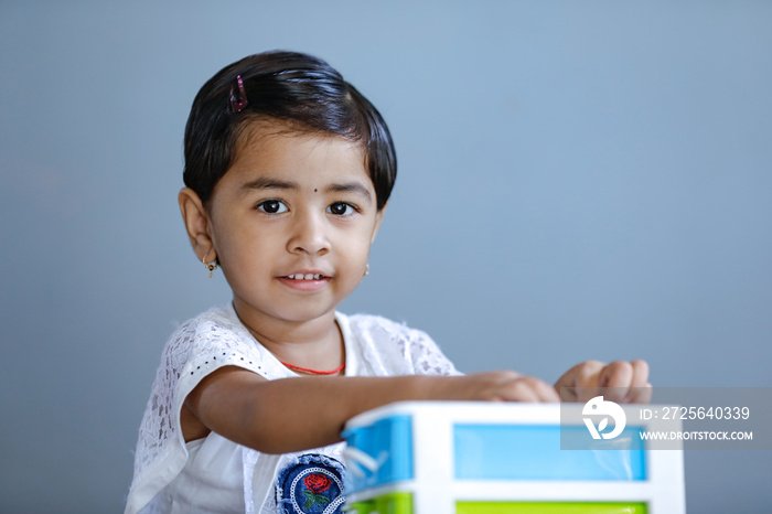 young indian girl playing at home