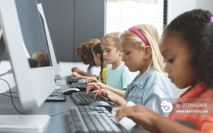 School kids using computer in school