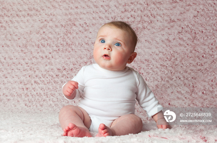 Newborn baby girl with white bodysuit