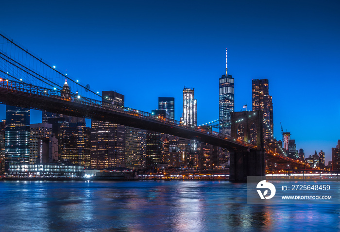 New York City Panoramic landscape view of Manhattan with famous Brooklyn Bridge at dusk .