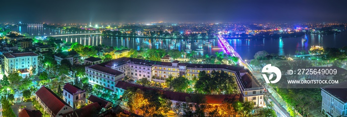 Panoramic city colorful night sparkling view from above in Hue, Vietnam.