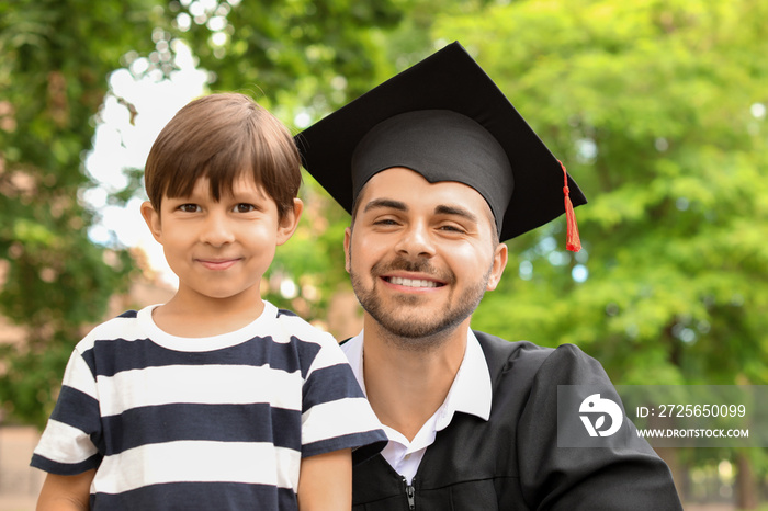 Man with his little son on graduation day