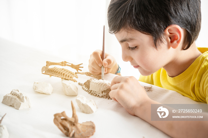 kid playing home alone with a scientific and precision game