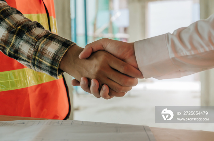 construction worker team contractor hand shake after finishing up a business meeting to greeting sta