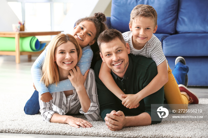 Happy couple with little adopted children at home