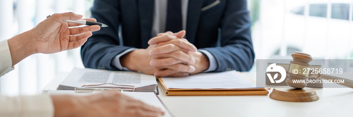 law concept The man in dark blue suit, a lawyer, sitting at his desk and trying to prepare to give l