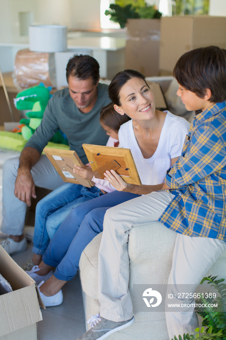 Family unpacking belongings in new house