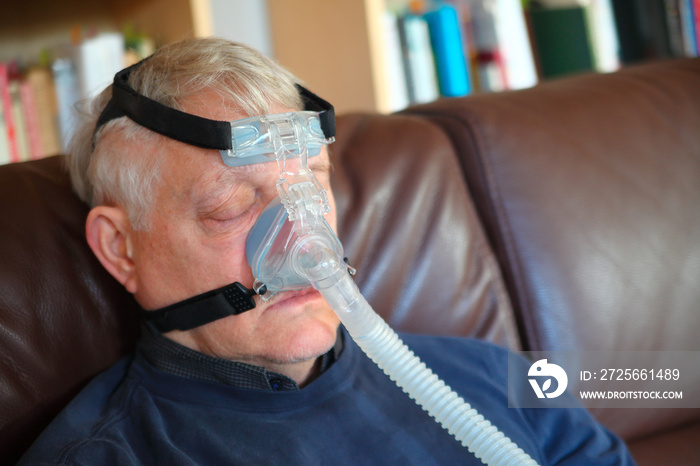 Man rests with CPAP device