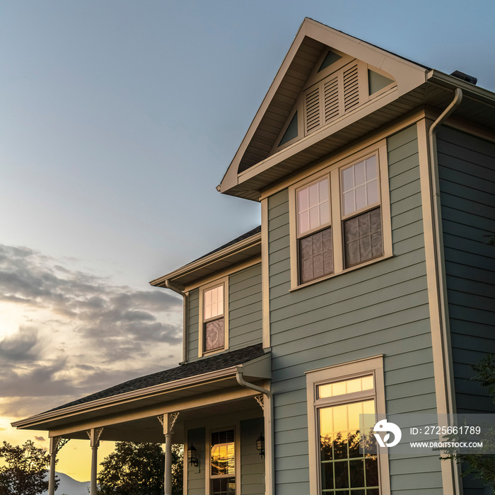 Square frame Sunset reflected in the windows of a timber house