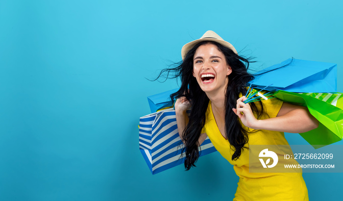 Woman with many shopping bags on a blue background