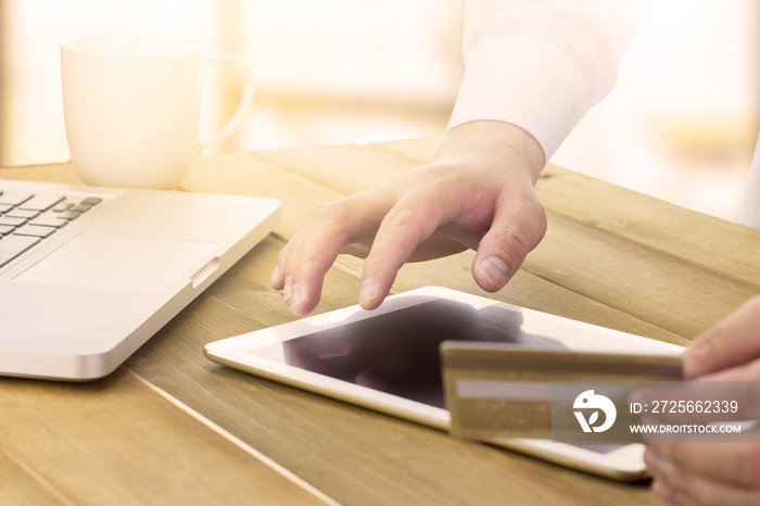 a man using his digital tablet and holding credit card intent to shopping online concept, digital bu