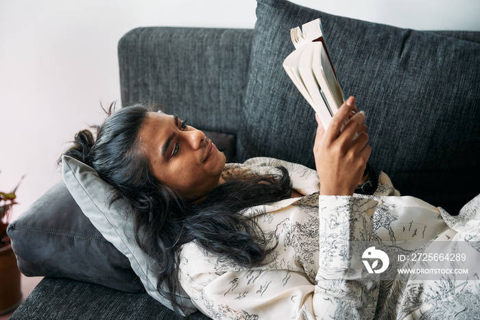 Gender fluid person reading a book