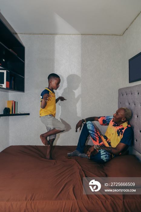 Little boy entertaining father in room