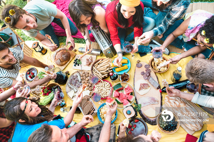 High angle top view of multiracial friends group having fun outdoor cheering at bbq pic nic with sna