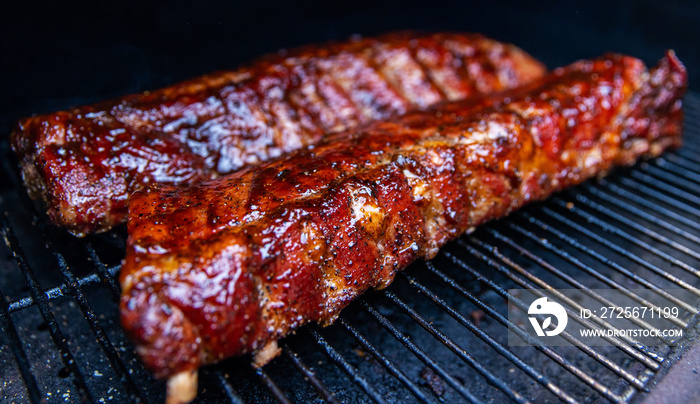 Babyback pork ribs cooking on a pellet grill smoker