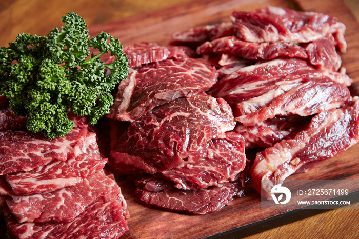 Various cuts of raw beef on a cutting board