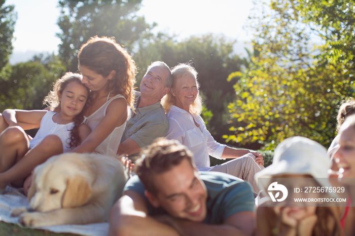 Multi-generation family, relaxing in sunny backyard