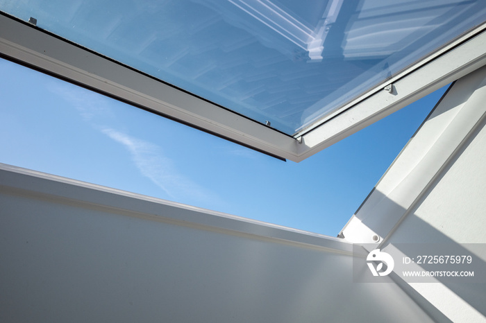 Interior view and close-up detail at open white Tilt Window Skylights at attic and background of sun