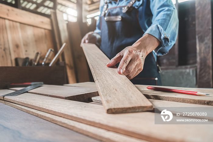 Carpenter working with equipment on wooden table in carpentry shop. woman works in a carpentry shop.