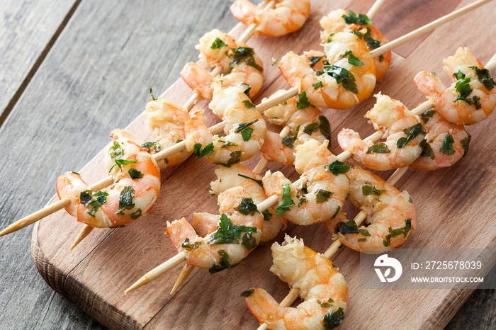 Shrimp skewers on wooden table