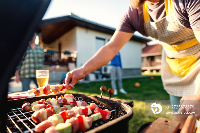 Close up of grilled vegetables and meat on sticks on grill. Family gathering concept.