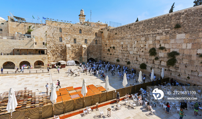 Praying people at the Wailing Wall. Visible division into two separate parts - for men and for women