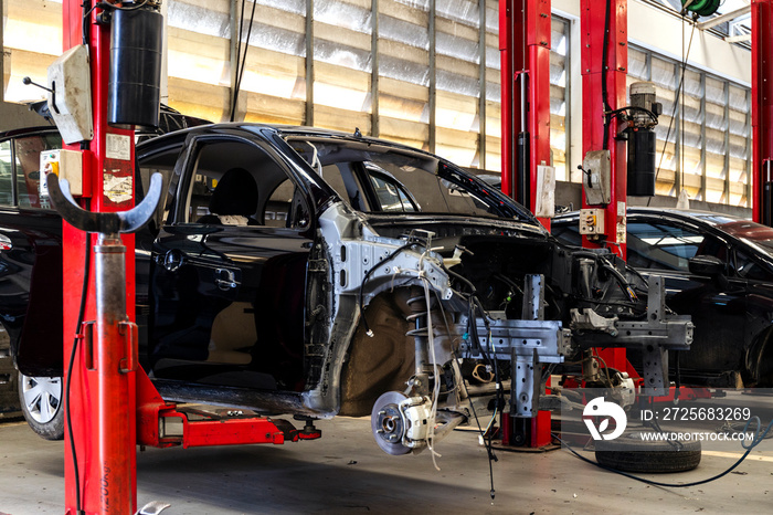 car in automobile repair service center with soft-focus and over light in the background