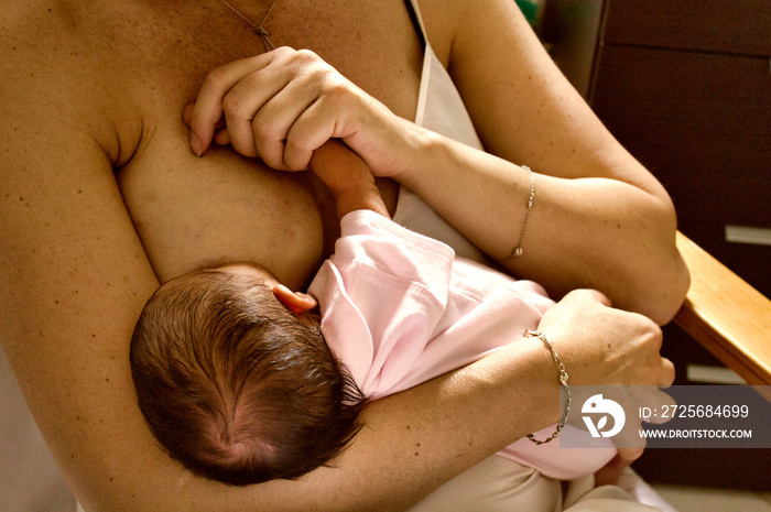 Mother breastfeeding her newborn baby boy. Mom nursing and feeding small kid