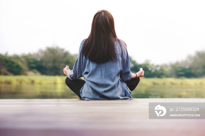 Young Woman Practices Yoga in Outdoor. Sitting in Lotus Position. Unplugged Life and Mental Health C