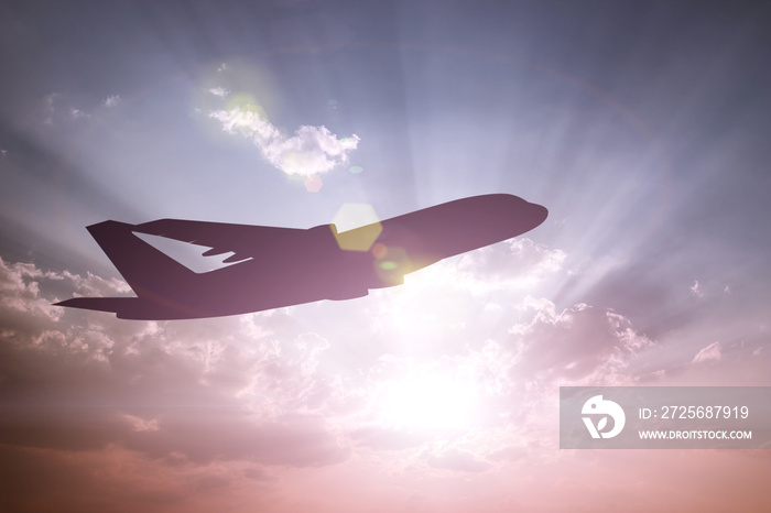 飞机剪影在日落背景下的色彩缤纷的天空中起飞