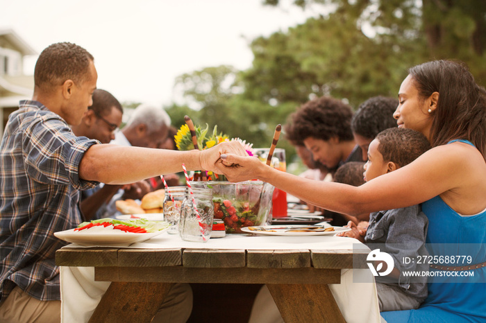 Family praying before lunch