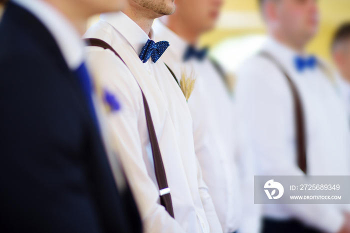 Groomsmen during catholic wedding ceremony