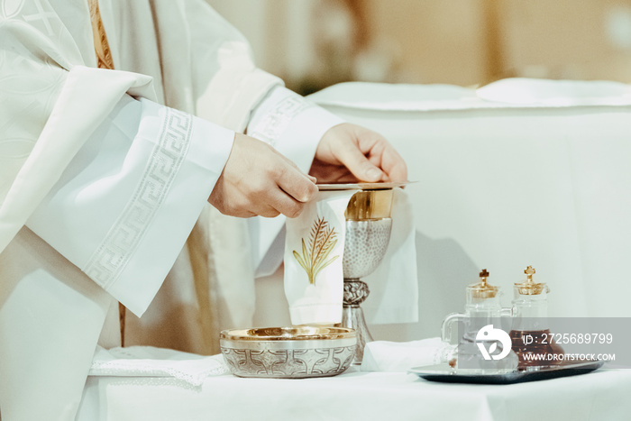 Christian priest prepares the supplies for the consecration liturgy.