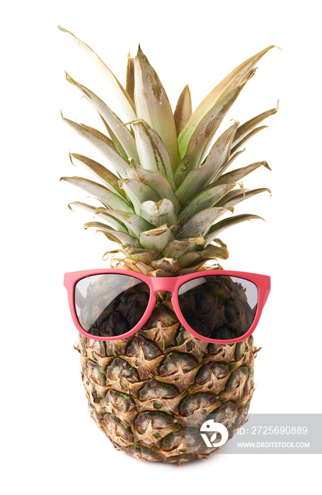 Whole pineapple with sunglasses isolated over white background