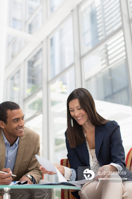 Smiling business people meeting in lobby