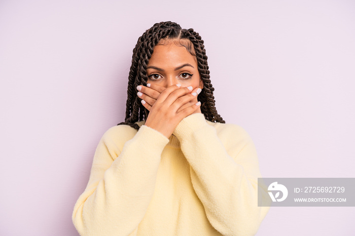 black afro woman covering mouth with hands with a shocked