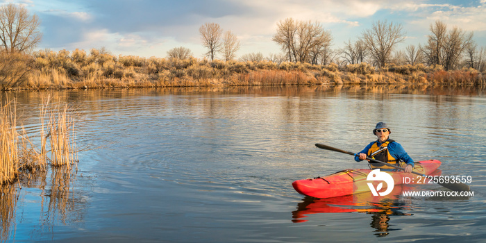 kayak paddling on lake in early spring