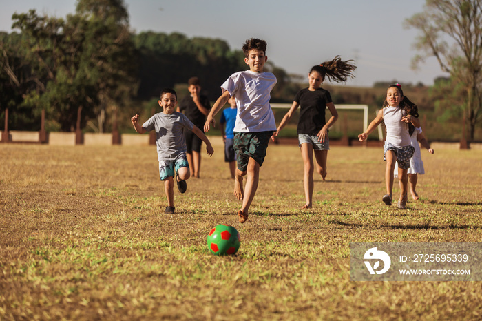 Children on soccer field running and playing