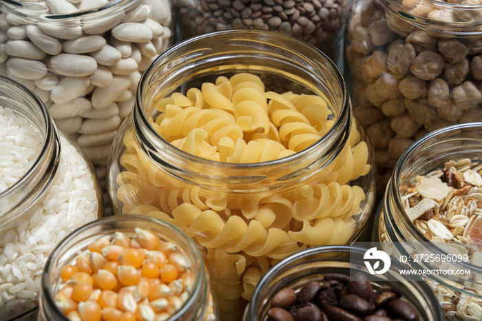 Set of glass jars with various ingredients placed on a table. Zero waste concept.