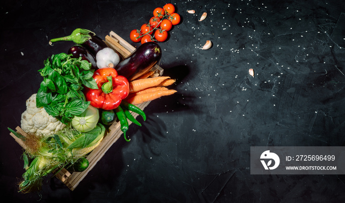 Healthy food background. Concept of healthy food, fresh vegetables in box on a dark background