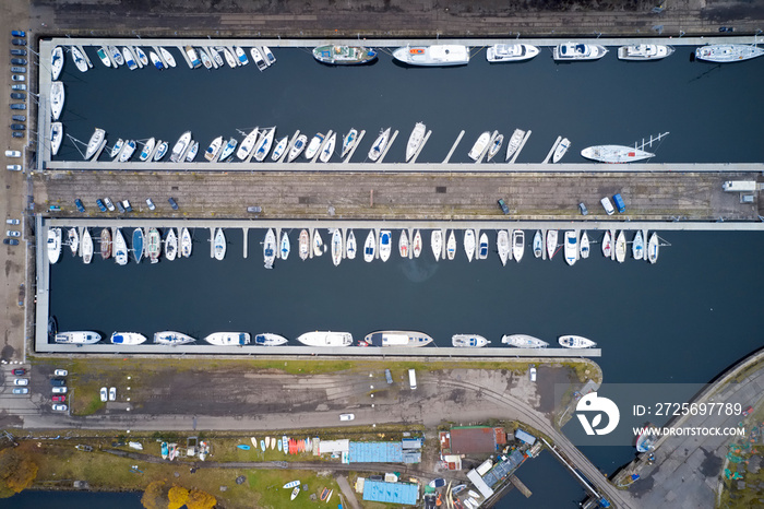 Aerial view of Marina with boats and yachts from above in row and pontoon