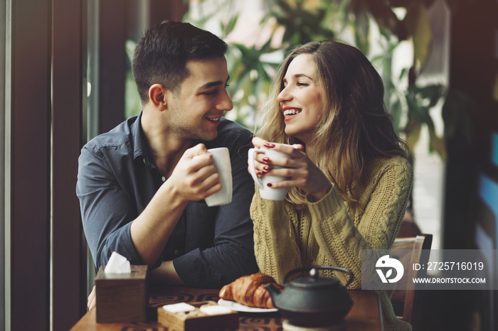 Couple in love drinking coffee in coffee shop