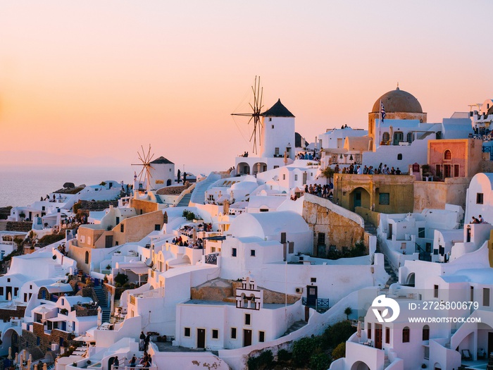 Oia traditional cave houses in Santorini, Greece at sunset